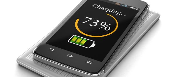 Wireless charging of smartphone (clipping path included)
